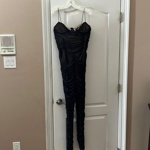 Shirred black jumpsuit with tan lining. Spaghetti straps